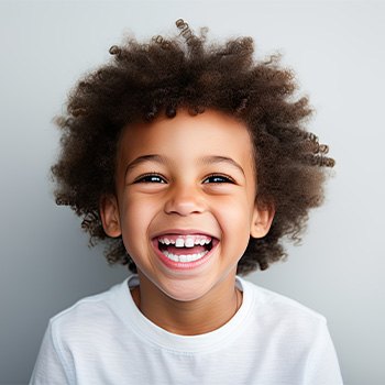 Happy, smiling little boy in white t-shirt